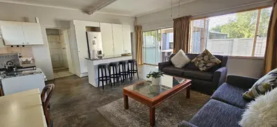 a living room with a couch and a table at Meander Sky in Centurion
