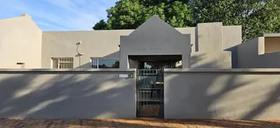 a building with a gate in front of it at Meander Sky in Centurion