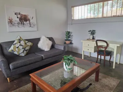 a living room with a couch and a table at Meander Sky in Centurion