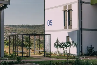 a view from the side of a building with two benches at Lethukukhanya Luxury Apartment in Nelspruit