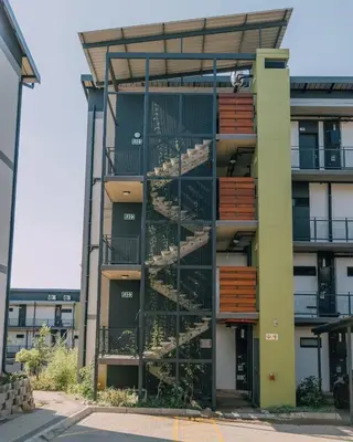 an apartment building with stairs on the side at Lethukukhanya Luxury Apartment in Nelspruit