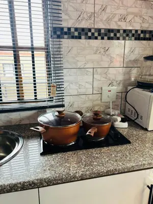 two pots sitting on top of a stove in a kitchen at The Hideaway Cabin in Pretoria