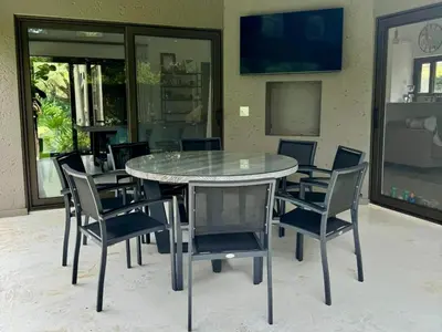 a glass table and chairs in a room at Pecanwood Paradise in Hartbeespoort