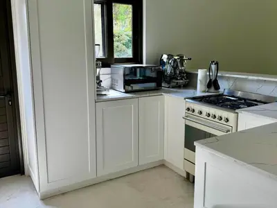 a white kitchen with a stove and a microwave at Pecanwood Paradise in Hartbeespoort