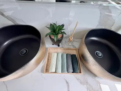 a bathroom with two sinks and a box of towels at Pecanwood Paradise in Hartbeespoort