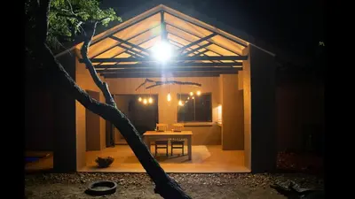 a house with a light on the top of it at Ratel Katel in Marloth Park