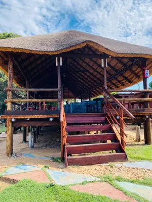 a pavilion with stairs and a straw roof at Graceland Recreation in Erasmus