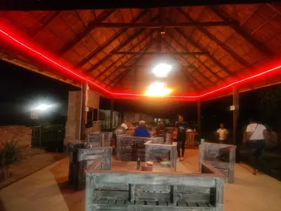 a restaurant with red lights and a table in the middle at Graceland Recreation in Erasmus
