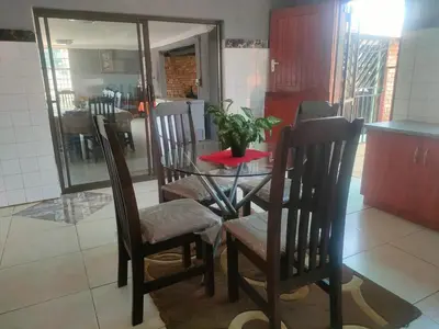 a table and chairs with a plant on top of it at Graceland Recreation in Erasmus