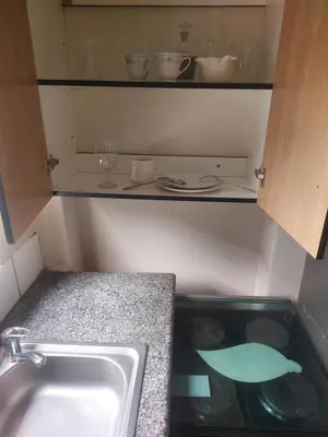 a kitchen with a sink and a counter top at American horses in Pretoria