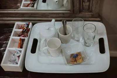 a tray with cups and glasses on a table at Santai guesthouse in Brits