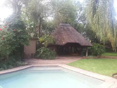 a gazebo and a swimming pool in a yard at Santai guesthouse in Brits