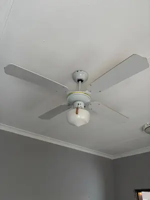 a ceiling fan with a light on a ceiling at Soft Spaces Haven in Pretoria