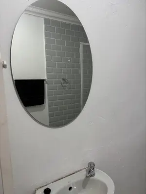 a bathroom with a mirror and a sink at Soft Spaces Haven in Pretoria