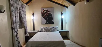 a bedroom with a large bed in a room at The Big Rondawel in Marloth Park