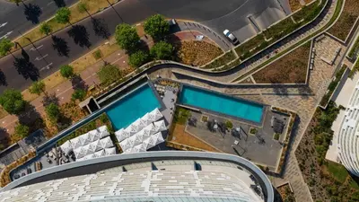 an overhead view of a building with two swimming pools at Bhonsane Executive Suite, Ellipse, Midrand in Midrand