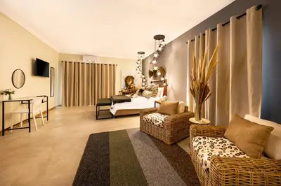 a living room with a couch and a bed at Zabini Lodge and Game Drives in Nelspruit