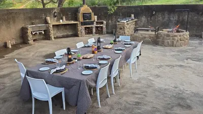 a long table with chairs and plates and drinks on it at Zabini Lodge and Game Drives in Nelspruit