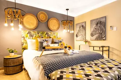 a bedroom with a bed with hats on the wall at Zabini Lodge and Game Drives in Nelspruit