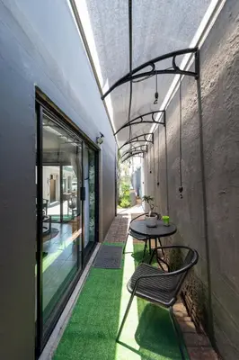 a patio with a table and chairs on a building at Polka Dot Airport Exec Suite in Kempton Park