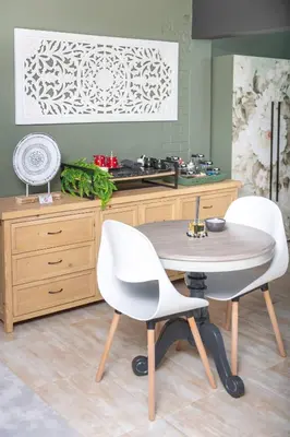 a kitchen with a table and two white chairs at Polka Dot Airport Exec Suite in Kempton Park
