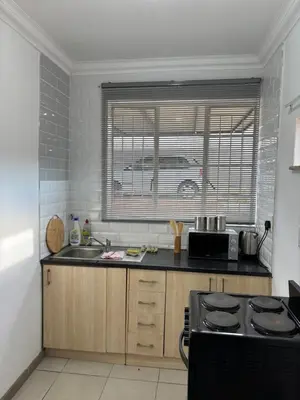 a kitchen with a sink and a stove top oven at Hideaway Haven in Pretoria