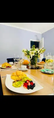 a wooden table with a plate of fruit on it at Morodi Guest Lodge in Witbank