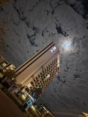 a tall building with the moon in the sky at Menlyn Maine Apartment with Sunbet Casino view in Pretoria