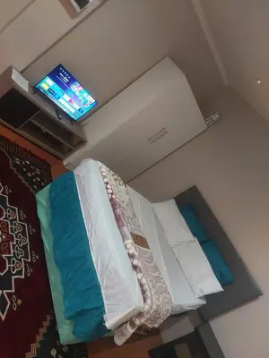 a bed in a room with a tv on the ceiling at American horses 2 in Pretoria