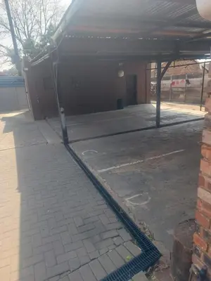 an empty parking lot in front of a building at American horses 2 in Pretoria