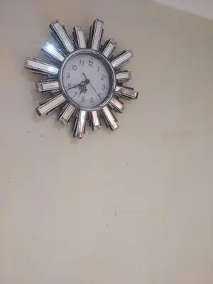 a clock is hanging on a wall at American horses 2 in Pretoria