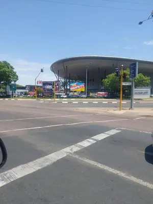 an empty parking lot with a building in the background at American horses 2 in Pretoria