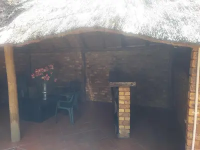 a patio with a table and a chair and a brick wall at American horses 2 in Pretoria