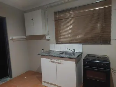 a small kitchen with a sink and a stove at American horses 2 in Pretoria