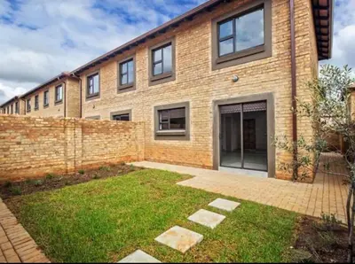 a brick building with a yard in front of it at Tranquil Willows in Pretoria