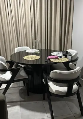 a black dining room table with chairs and wine glasses at Tranquil Willows in Pretoria