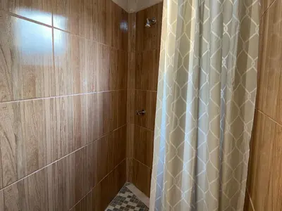 a shower with a shower curtain in a bathroom at The Fern Corner Guest House Unit 2 in Letaba