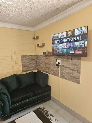 a living room with a couch and a television at MATSOP Guesthouse in Bela-Bela
