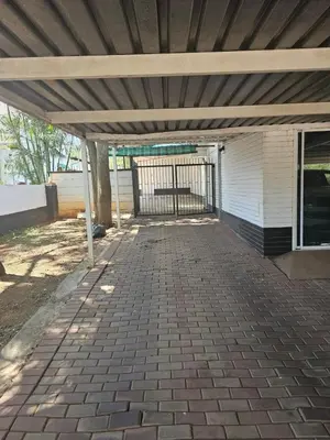 a patio under awning of a house with a gate at MATSOP Guesthouse in Bela-Bela