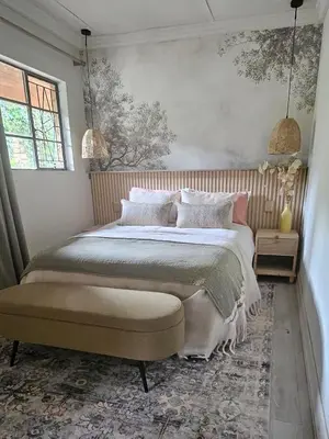 a bedroom with a large bed and a window at Manchester Farmstay in White River