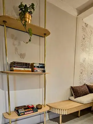a room with a shelf with books and a couch at Manchester Farmstay in White River