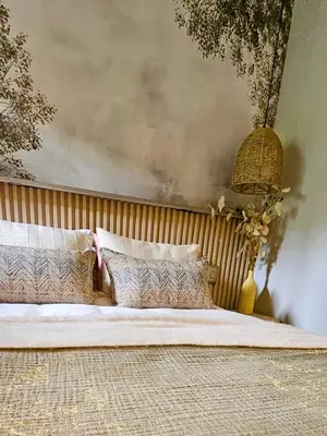 a bedroom with a large bed with pillows at Manchester Farmstay in White River