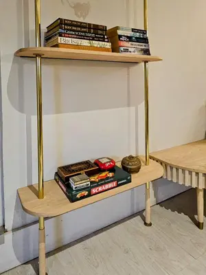 a wooden shelf with books on top of it at Manchester Farmstay in White River