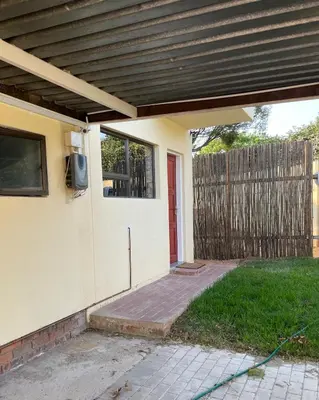 a porch with a tv on the side of a house at Serenity suite in Midrand