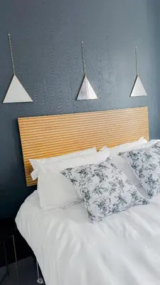 a bed with white pillows and a wooden head board at Serenity suite in Midrand