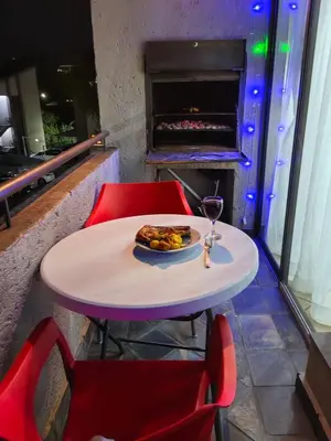 a table with a plate of food and a glass of wine at The Crown in Nelspruit