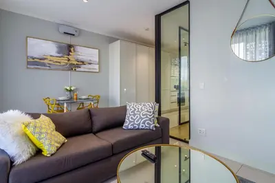 a living room with a couch and a table at Chic & Elegant at Ellipse in Midrand