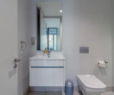 a white bathroom with a sink and a toilet at Chic & Elegant at Ellipse in Midrand