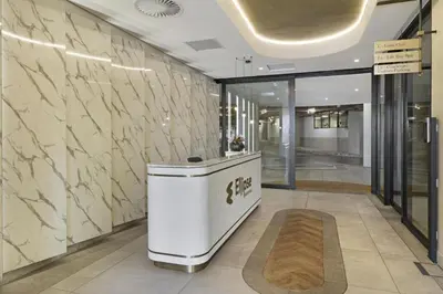 a lobby with a reception desk in a building at Chic & Elegant at Ellipse in Midrand