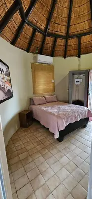a bedroom with a large bed in a room at The Truck Rondawel in Marloth Park